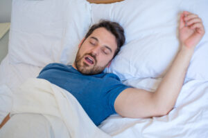 man snoring sleep apnea concept